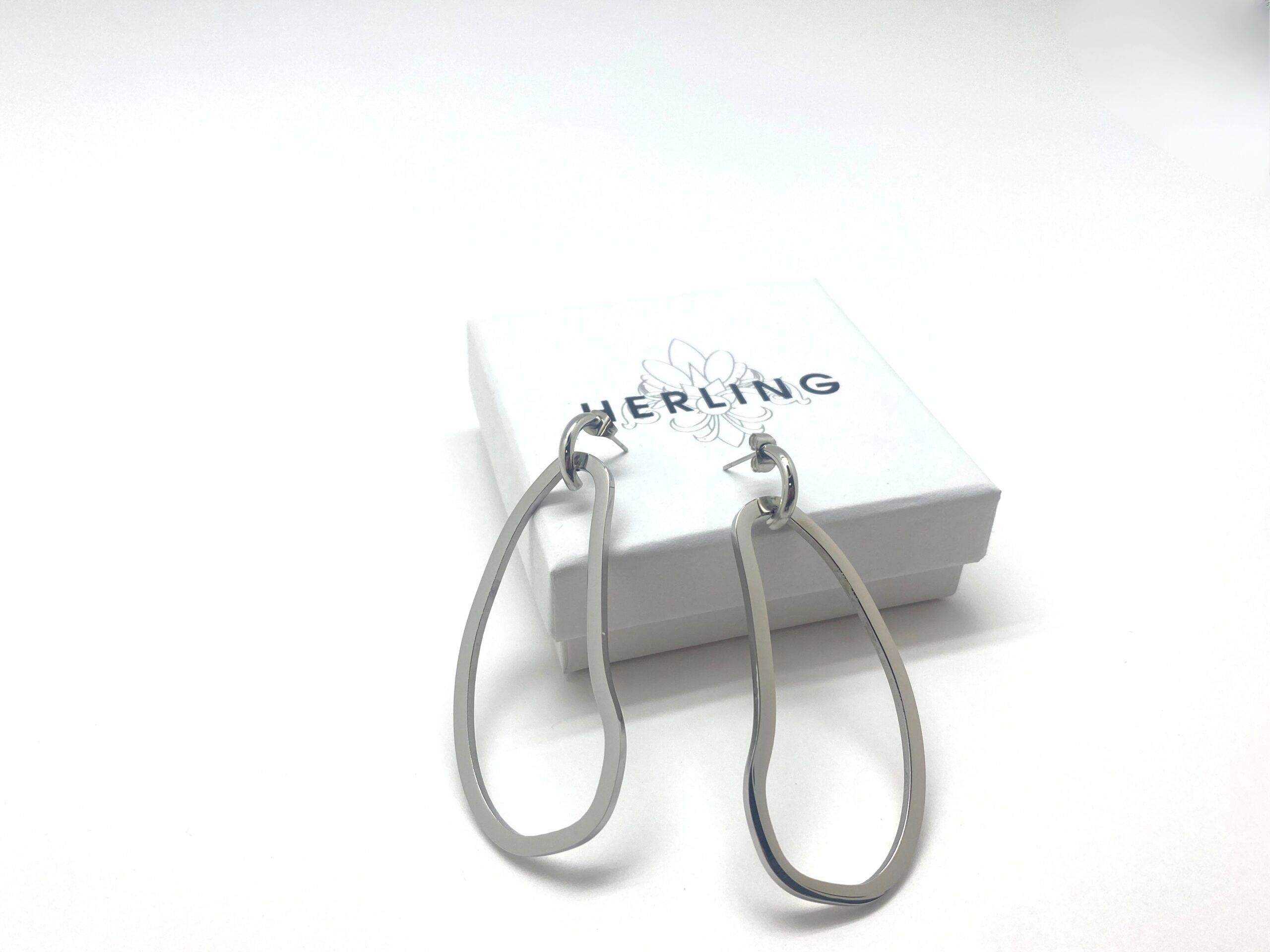 Sculptural drop earrings with fluid curves in stainless steel
