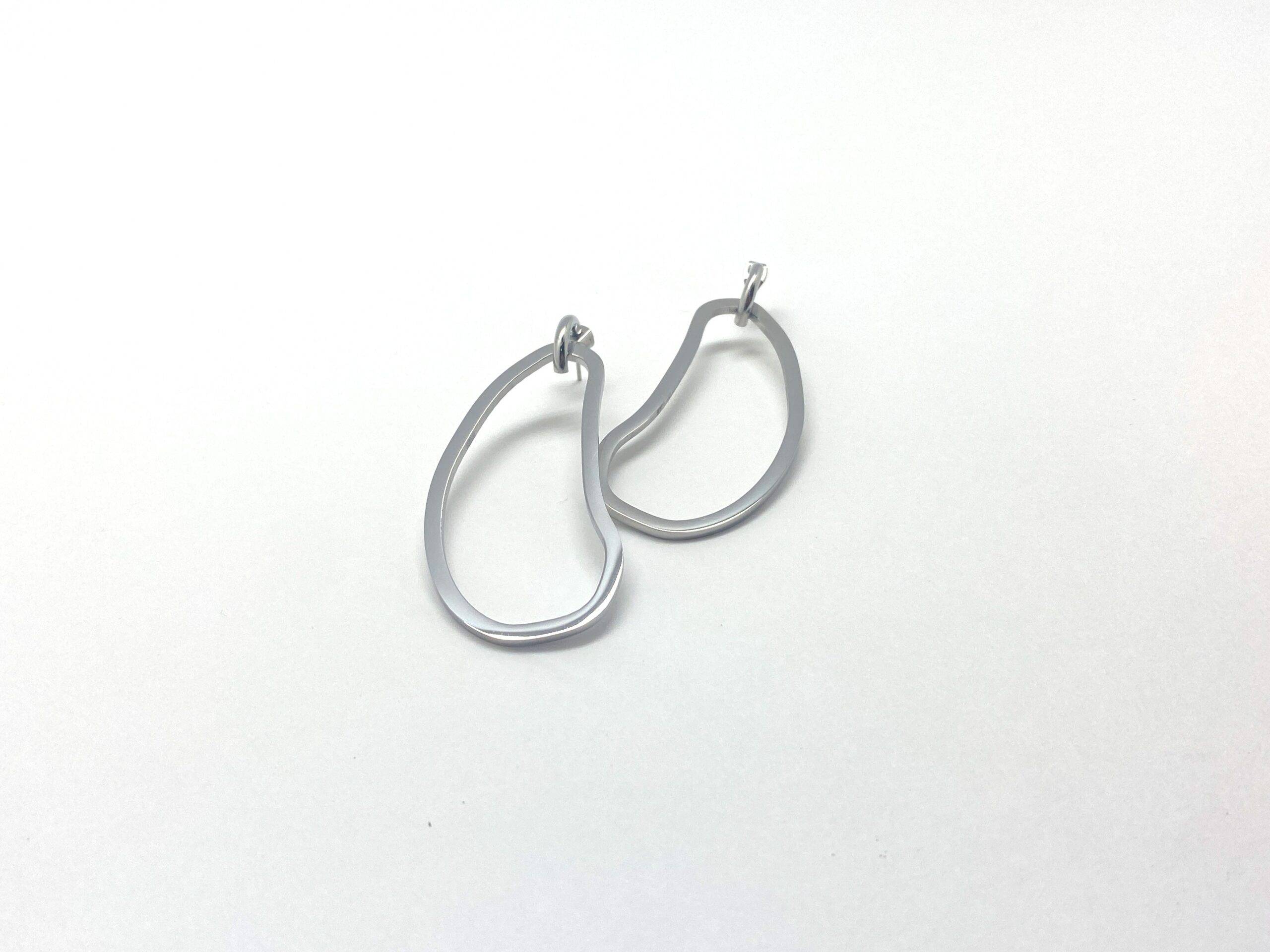 Sculptural drop earrings with fluid curves in stainless steel