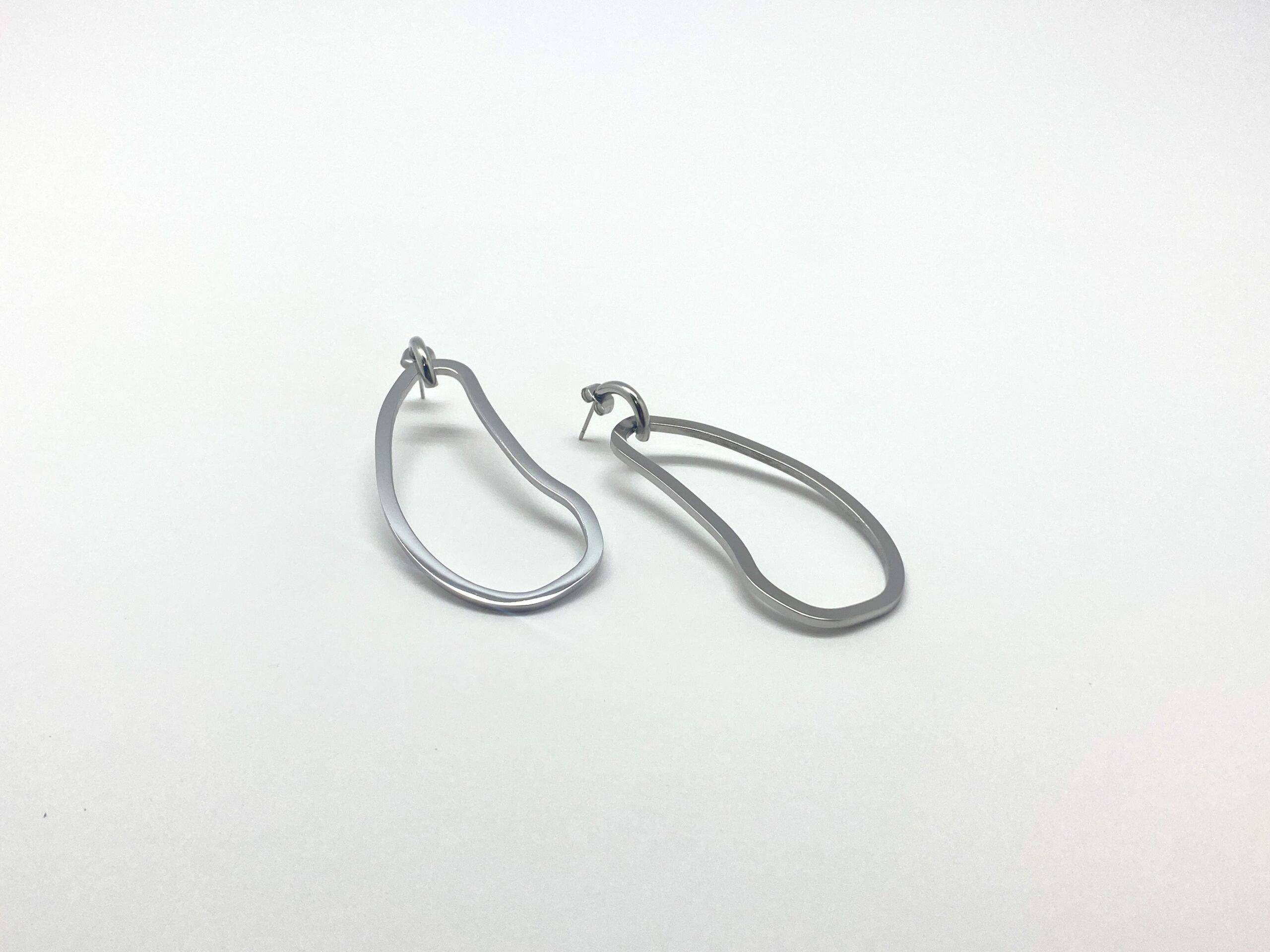 Sculptural drop earrings with fluid curves in stainless steel