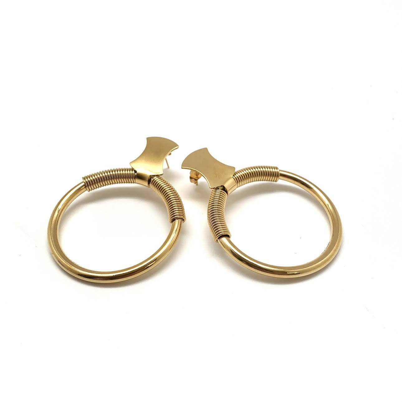 Vintage style gold hoops with classic 1960s-inspired curved top detail