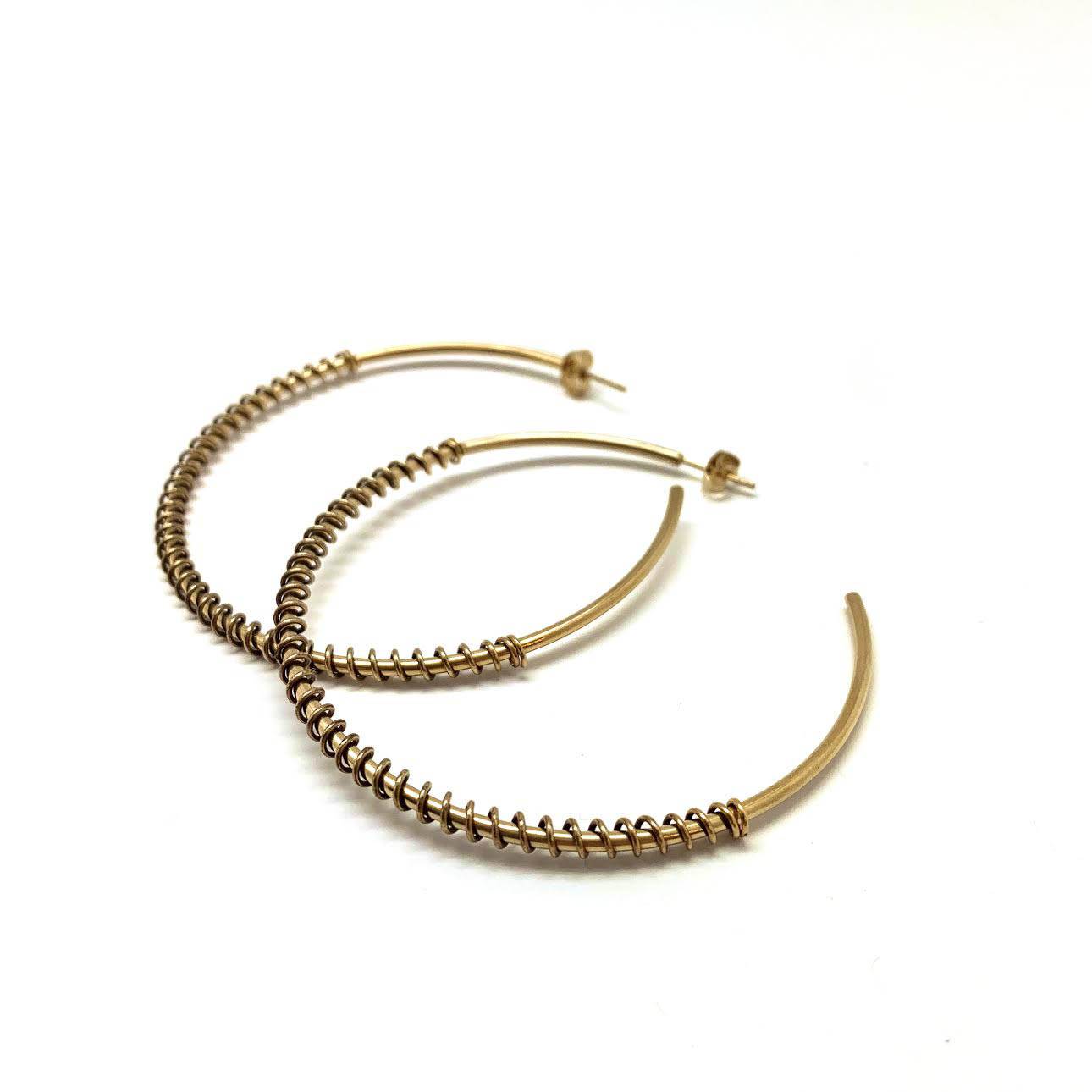 Electroplasma gold-plated spiral hoop earrings with a fluid, contemporary design.