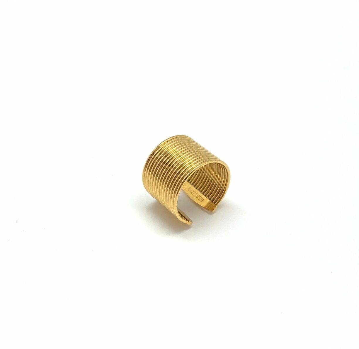 Gold architectural statement ring with linear wave pattern