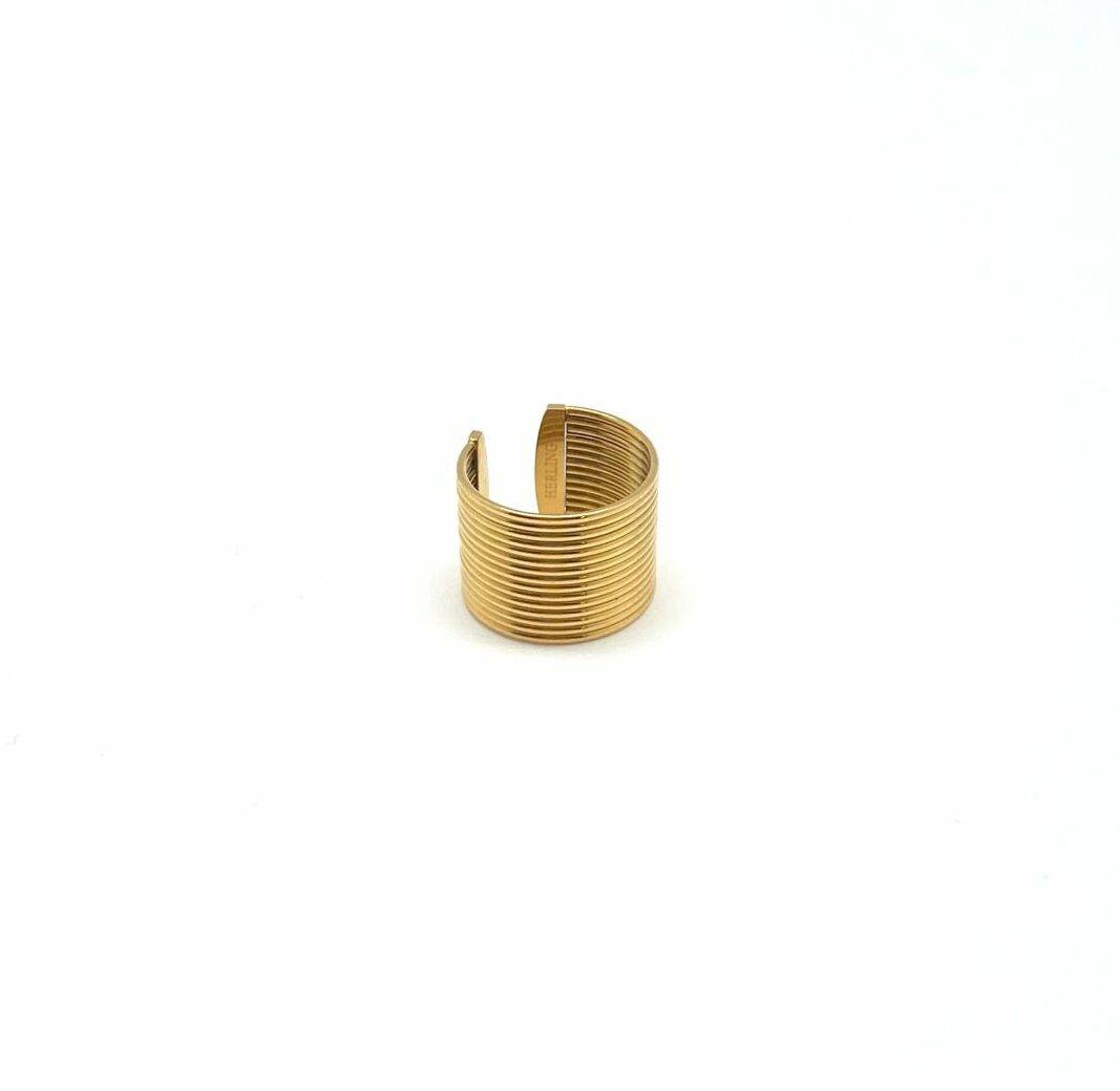 Gold architectural statement ring with linear wave pattern