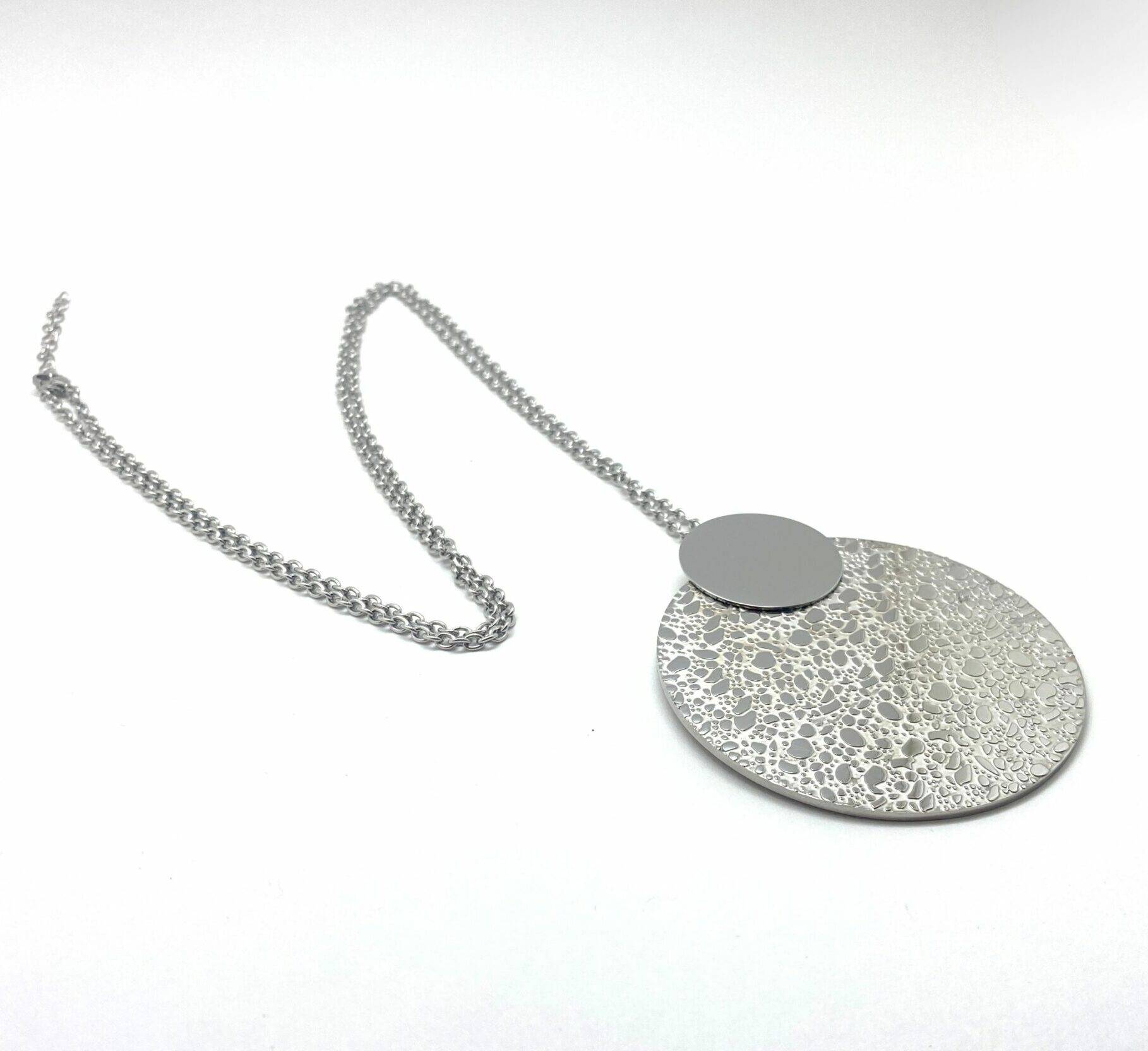 Long pendant necklace with textured disc in steel